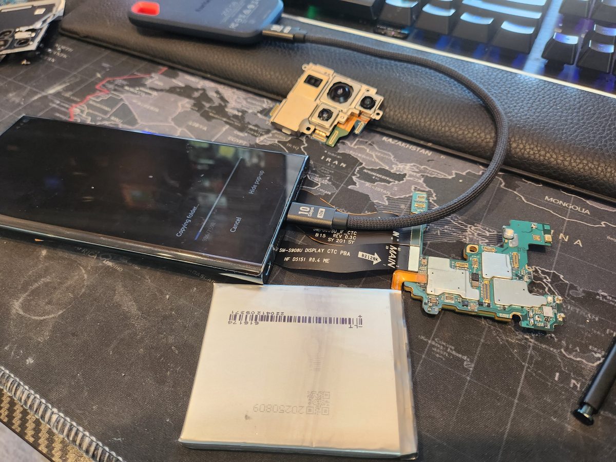 Phone disassembled for camera and logic-board repair at Device Hero, serving Pflugerville, TX