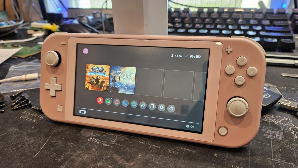 Nintendo Switch Lite powered on showing the home menu after a screen repair at Device Hero in Manor, TX