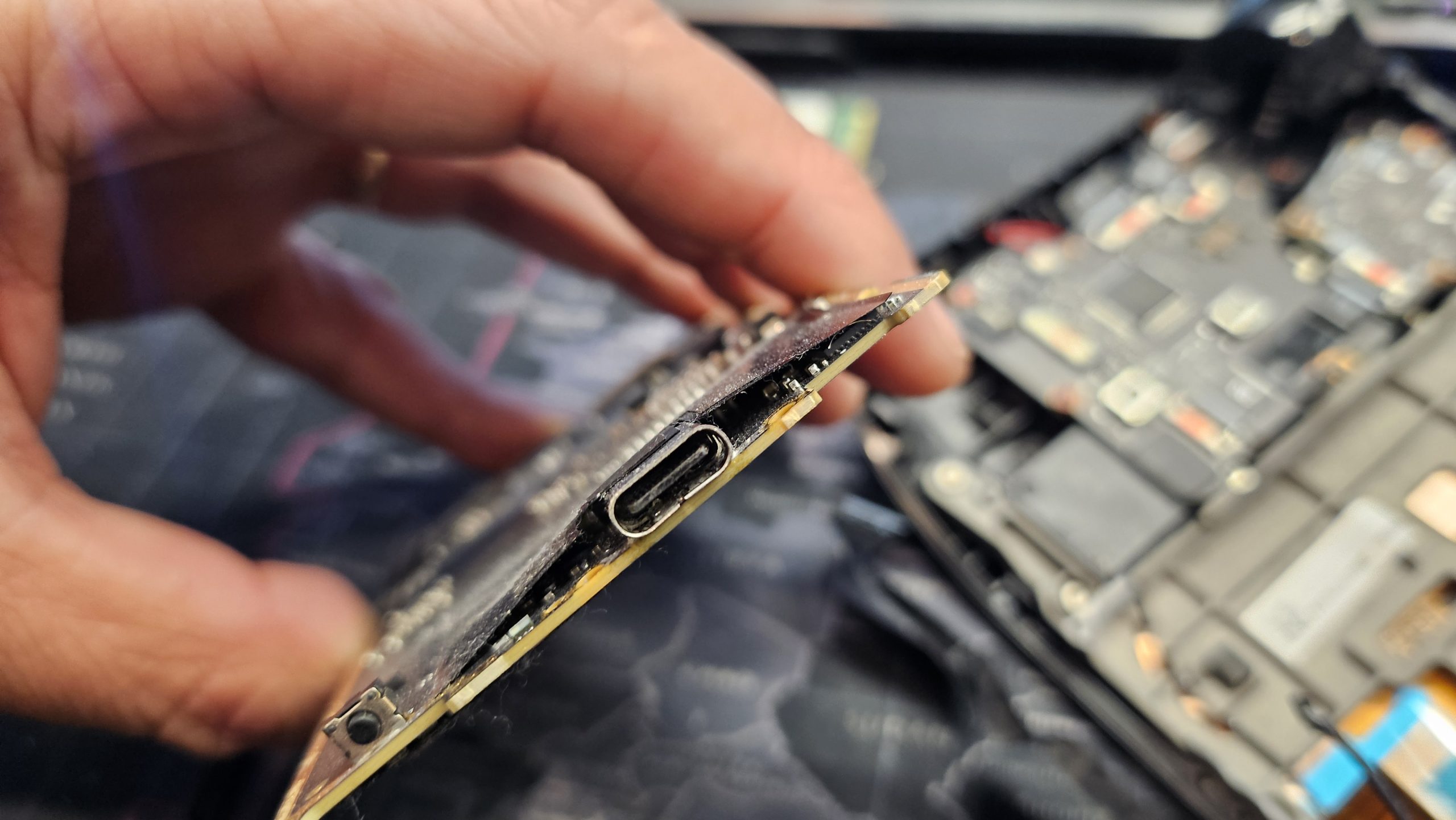 Removing a damaged charging port during a phone repair