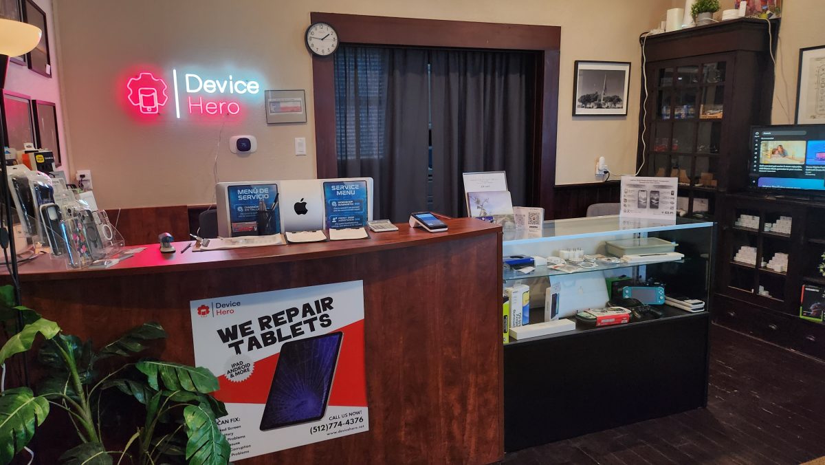 Device Hero front counter with the neon sign, service menu and display case